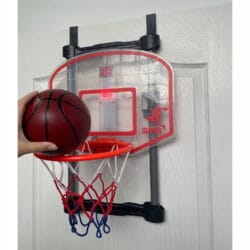 a hand holding a basketball in a hoop