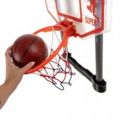 a hand holding a basketball in a hoop