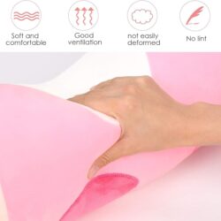 a hand holding a pink pillow