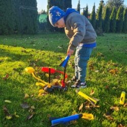 a child playing with a toy in the grass