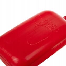 a red hot water bottle with a paw print