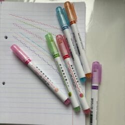 a group of markers on a notebook
